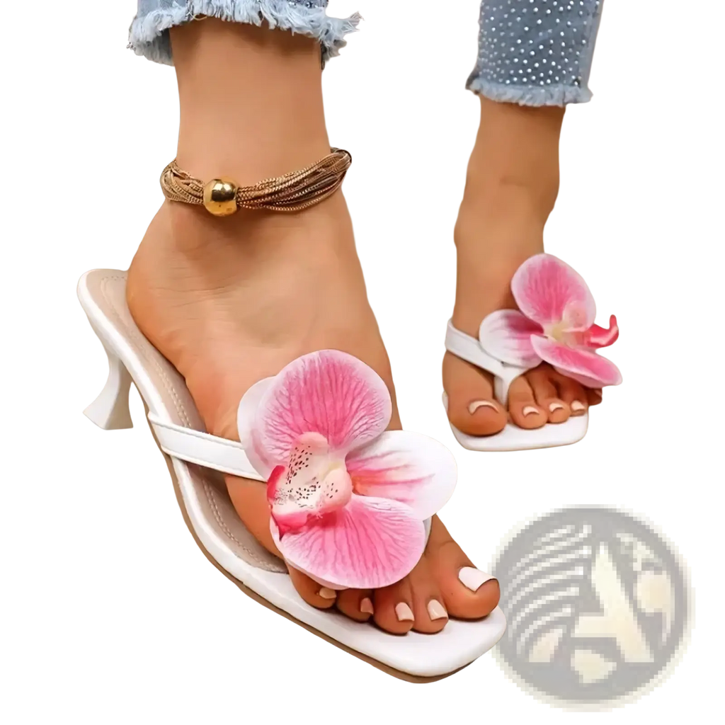 White heeled floral block heel mule sandals featuring large pink orchid flower decoration on a flip-flop design