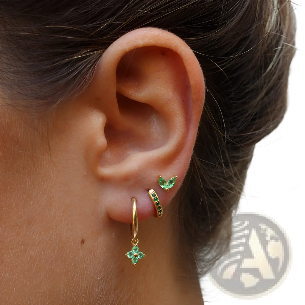 Gold hoop earring set with floral and butterfly design featuring emerald green gemstones in a gold tone