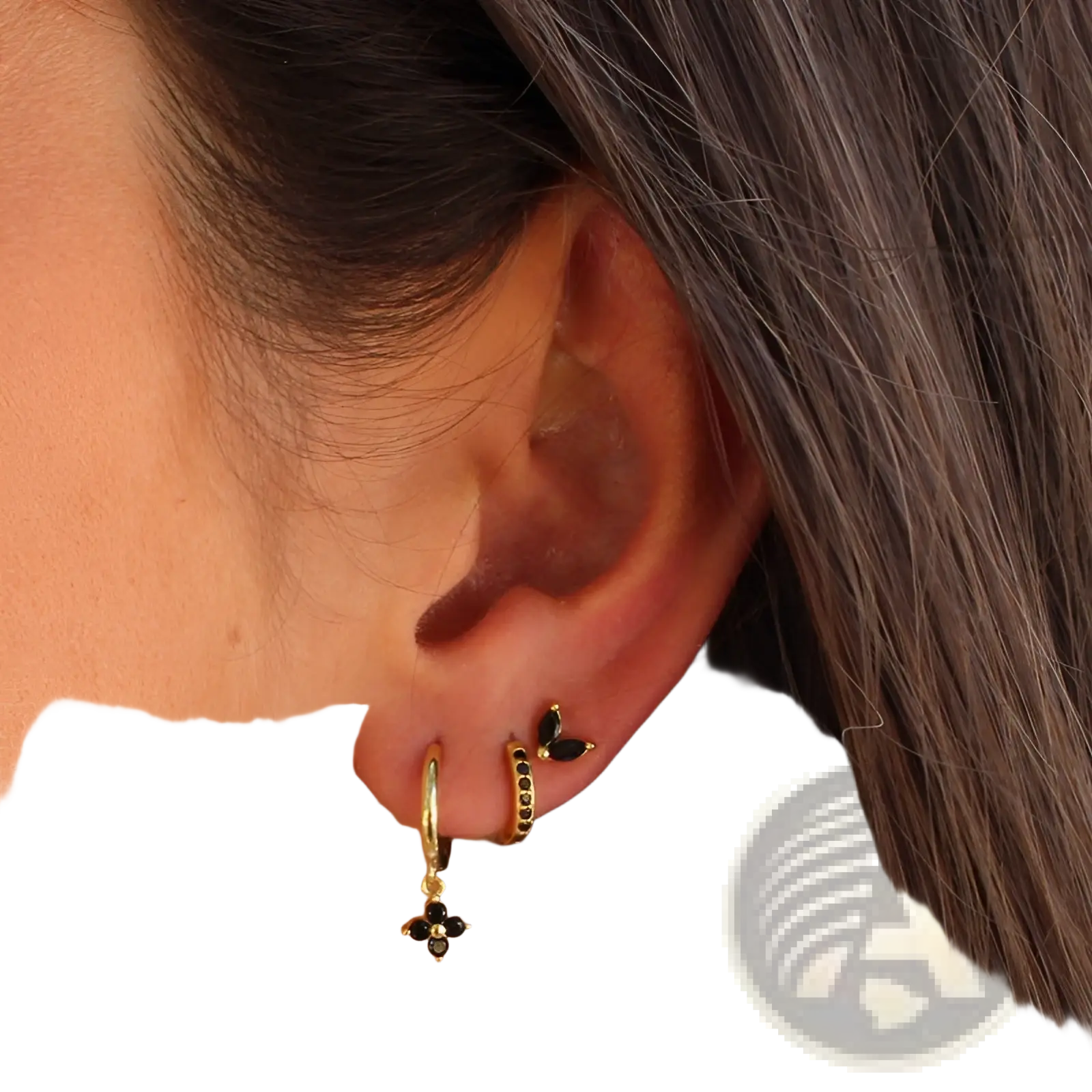 Gold-toned floral and butterfly hoop earrings with black gemstones and a delicate charm in a gemstone earring set