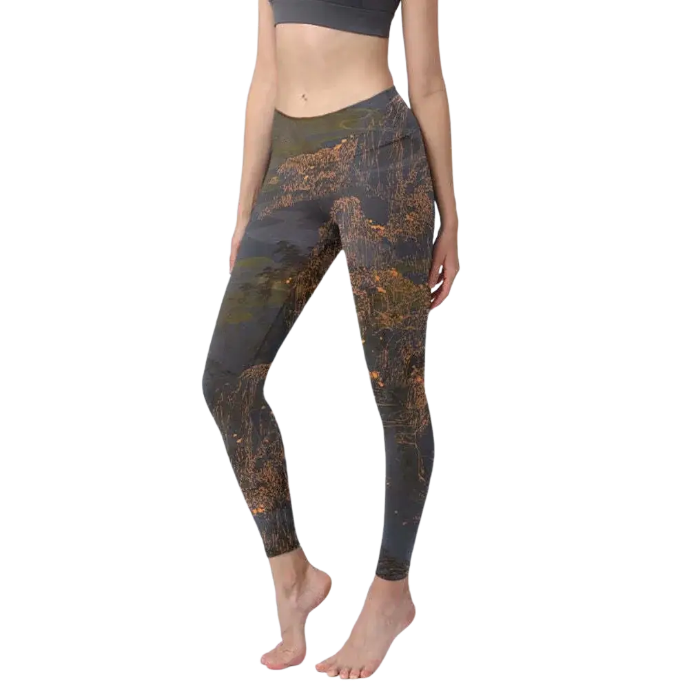 Dark gray high waisted yoga leggings with floral butterfly print and earthy toned landscape design with golden orange accents