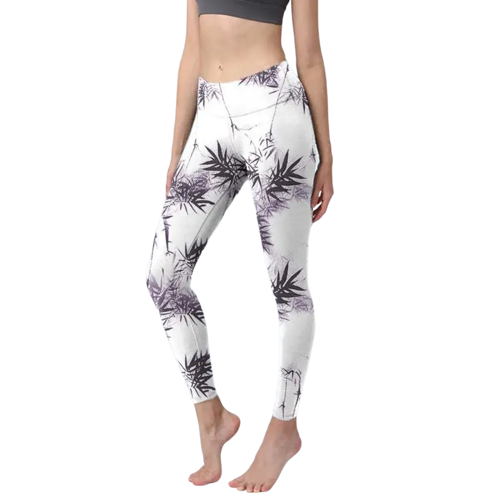 White high waisted yoga leggings with a black and purple bamboo leaf pattern featuring a floral butterfly print