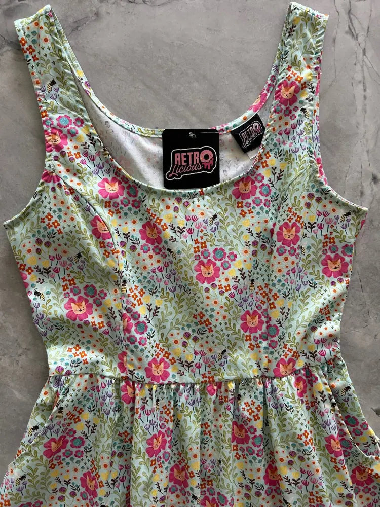 Floral cats light green cotton a-line dress with pockets featuring a playful floral pattern with smiling flowers