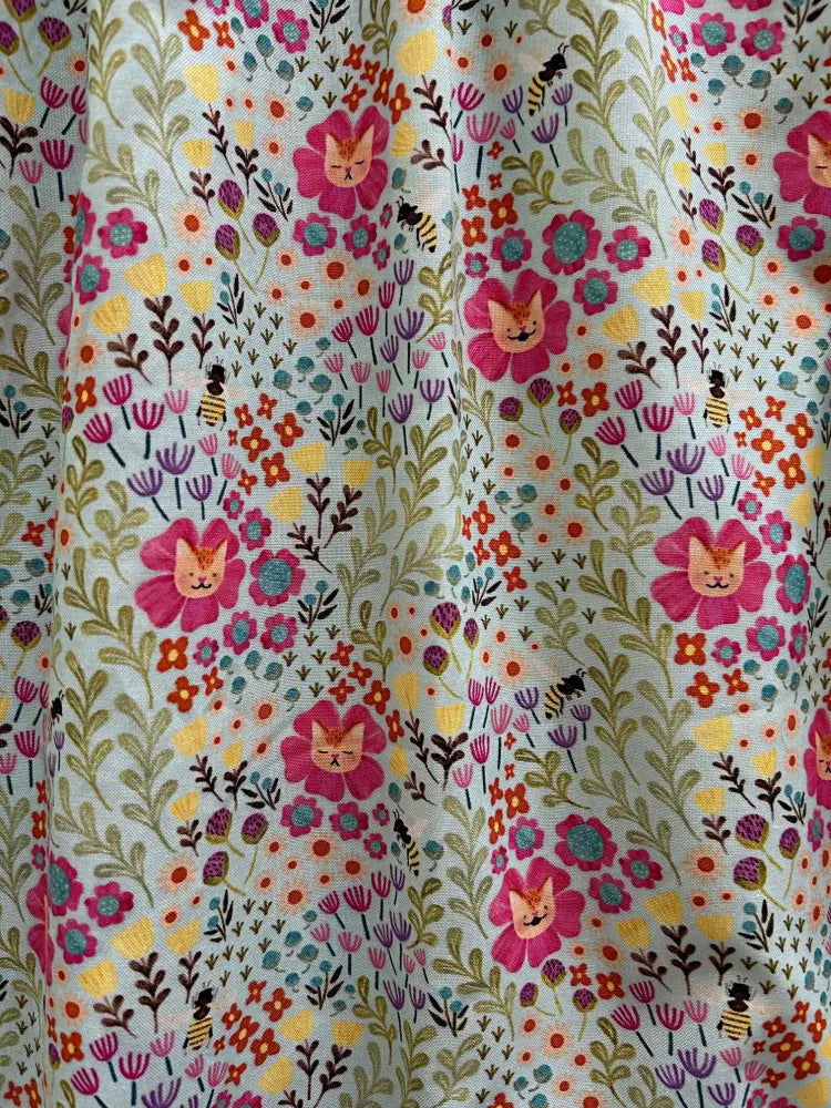 Floral cats light green cotton a-line dress with pockets featuring pink cat faces and colorful flowers pattern
