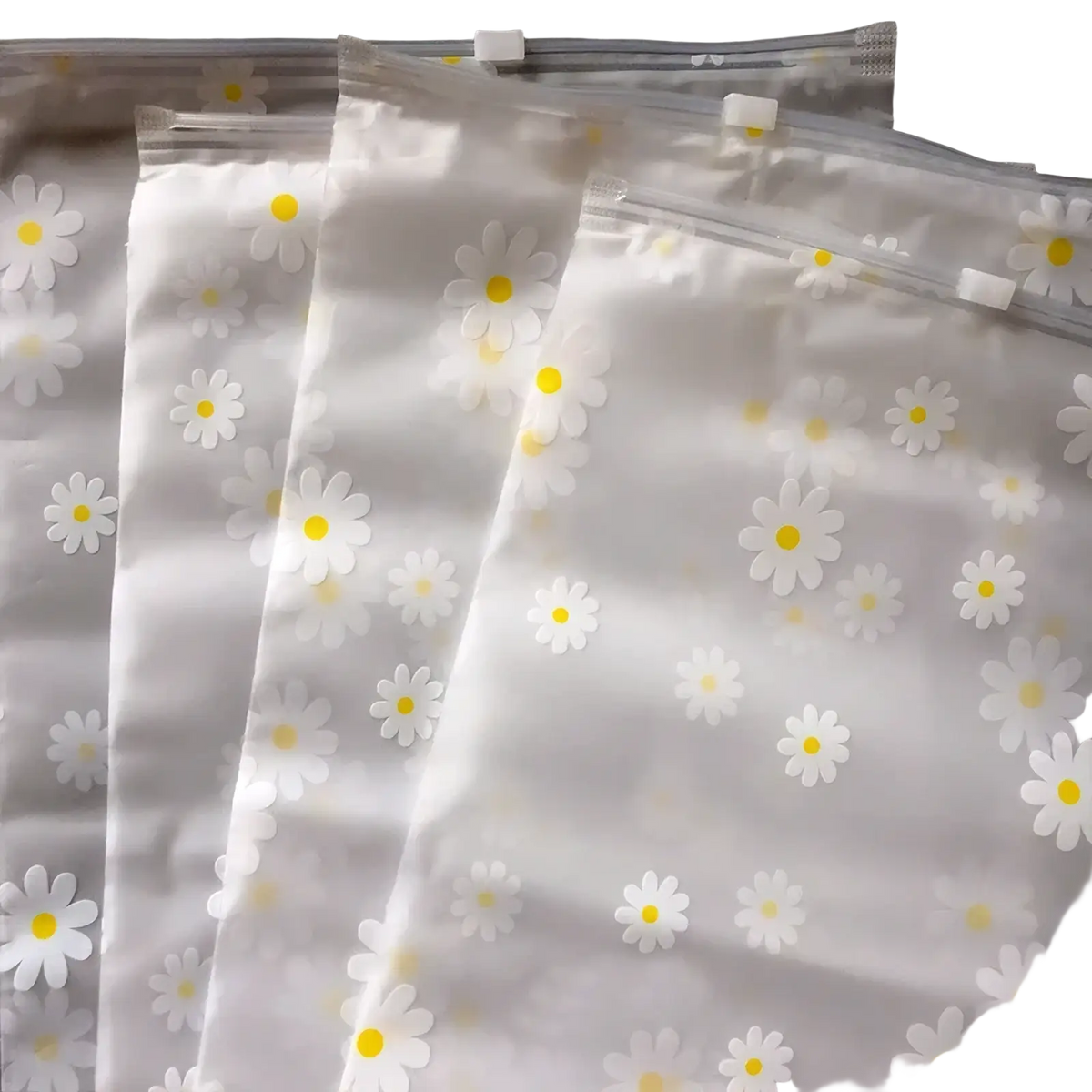 Floral clear travel cosmetic bag made of clear plastic with white daisies and yellow centers delicate pattern