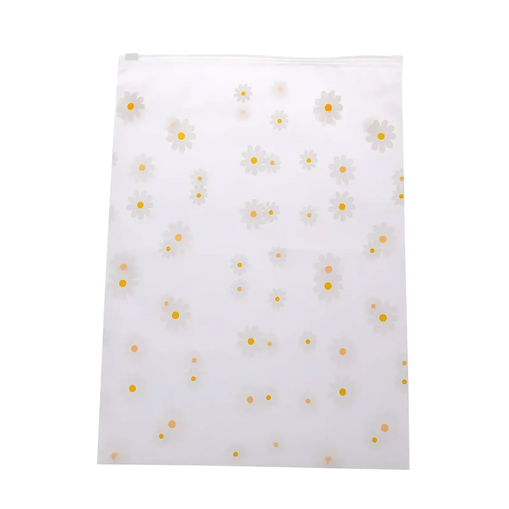 Floral clear travel cosmetic bag made of clear plastic with a zip top and white daisies with yellow centers pattern