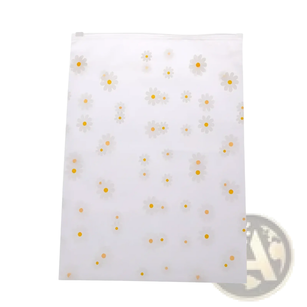 Floral clear travel cosmetic bag made of clear plastic with a zip top and white daisies with yellow centers pattern