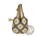 A beige crocheted floral tote bag featuring white and yellow daisy motifs for stylish shoulder use