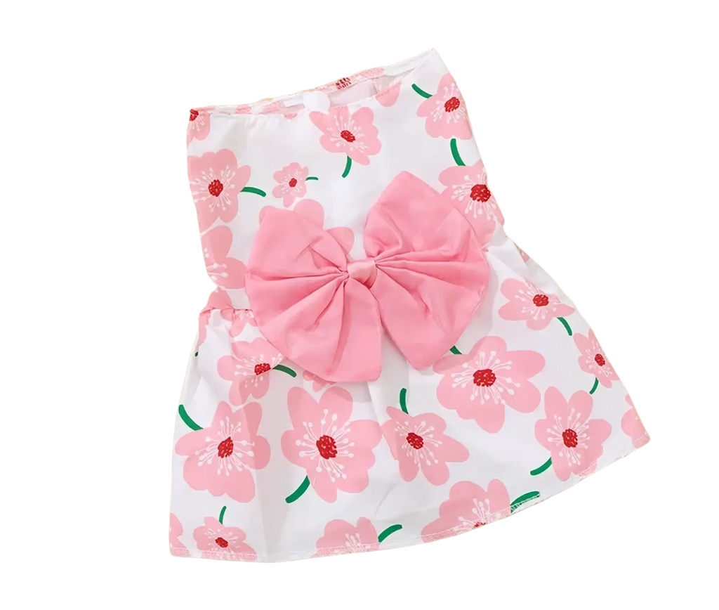 Floral dog princess dress in white with pink blossoms green stems and a large pink bow at the waist