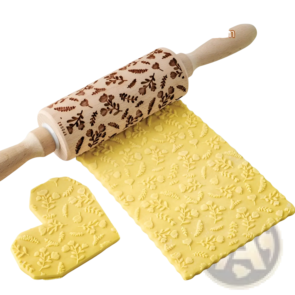 A wooden floral embossed beech wood rolling pin with engraved leaves acorns and light wood handles for baking