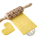 A wooden floral embossed beech wood rolling pin with engraved leaves acorns and light wood handles for baking