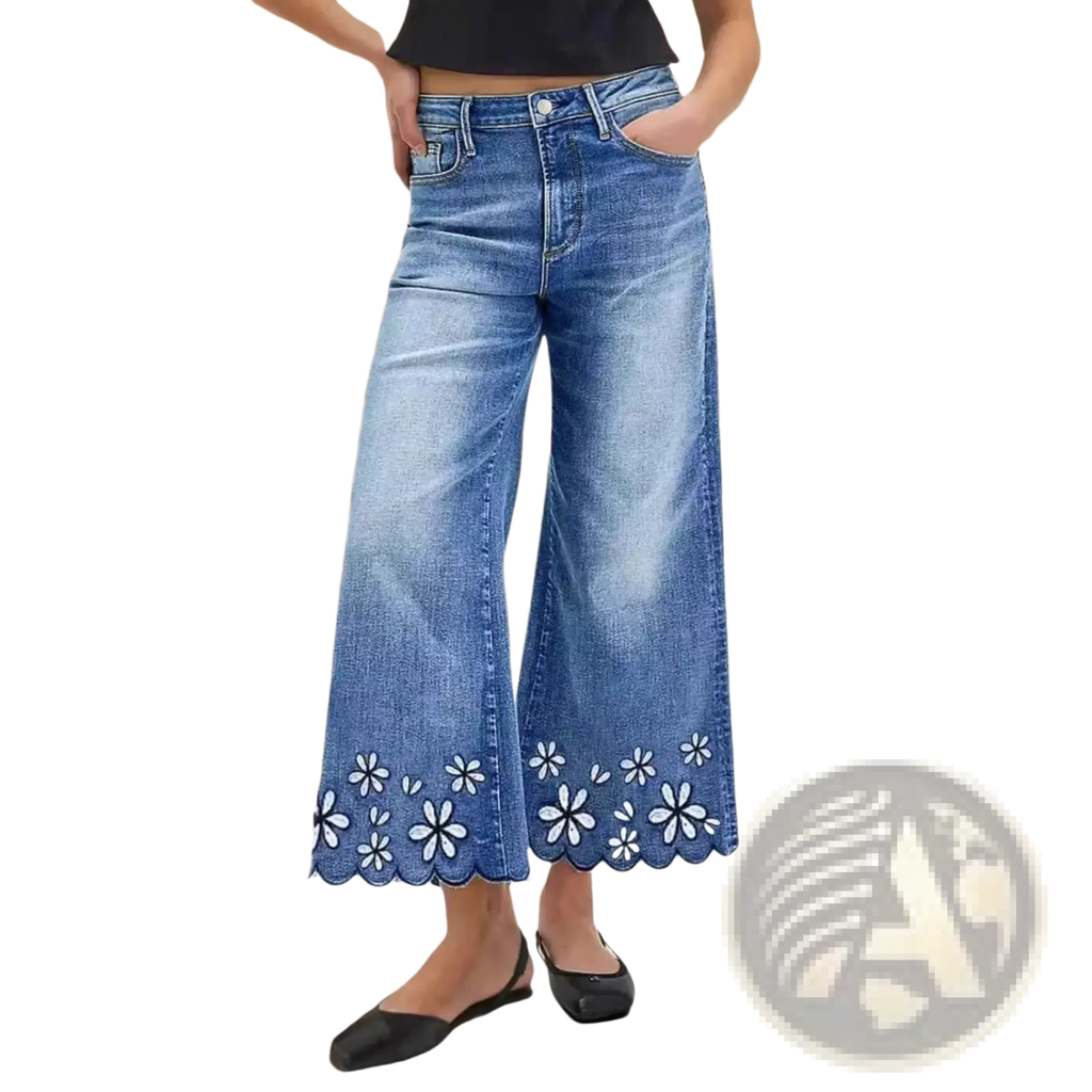Blue denim wide-leg pants with scalloped hem and white floral embroidery in a cropped style
