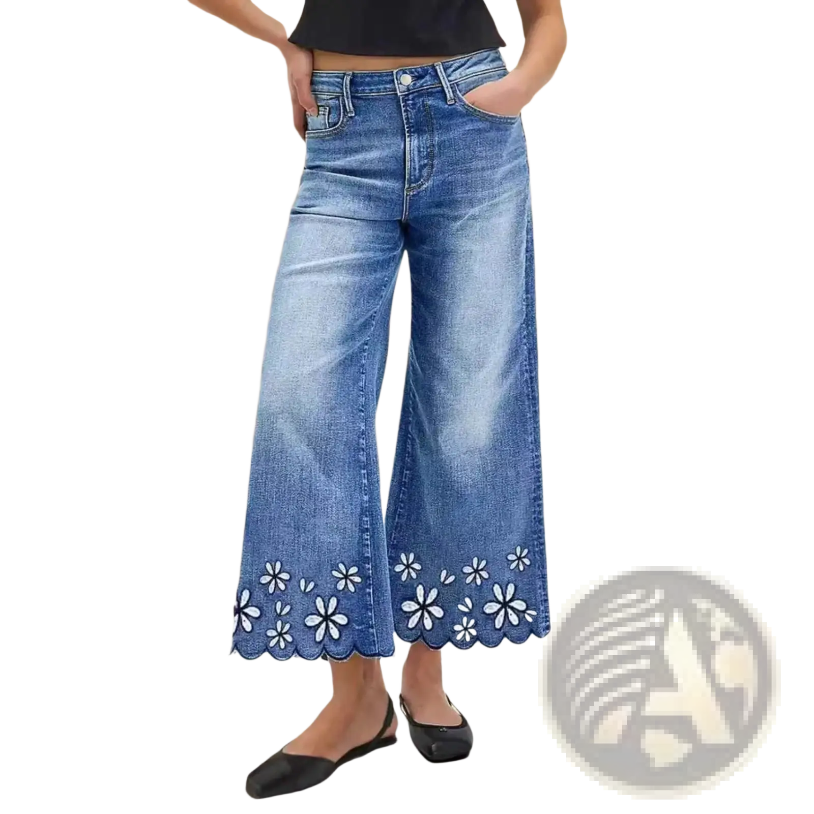 Blue denim wide-leg pants with scalloped hem and white floral embroidery in a cropped style