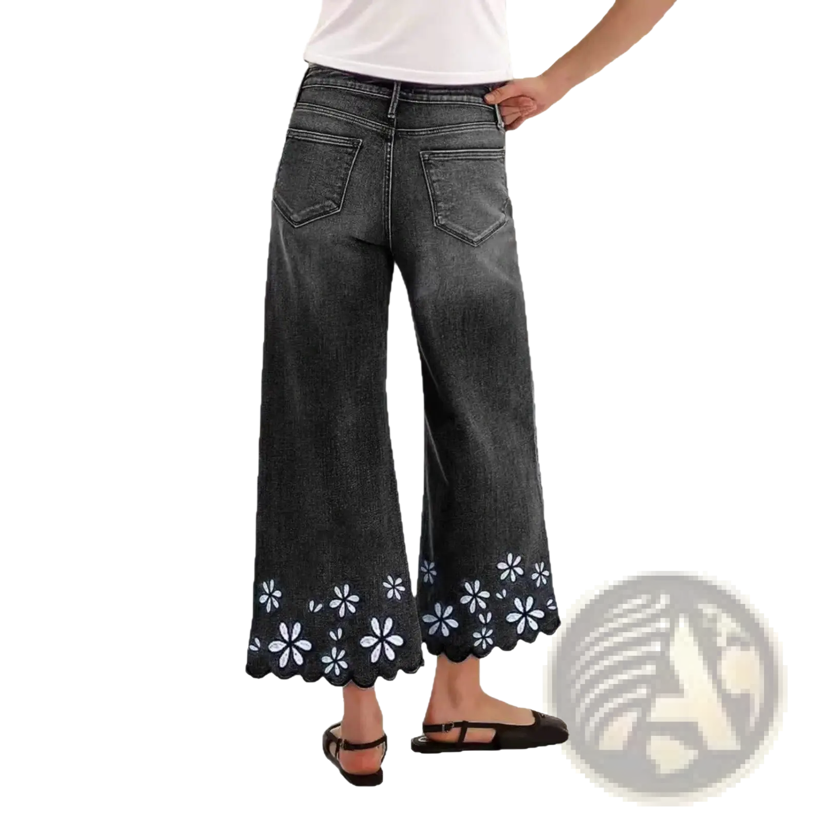 Dark gray denim wide-leg pants with scalloped hem and white floral embroidery in a floral embroidered cropped denim jeans style