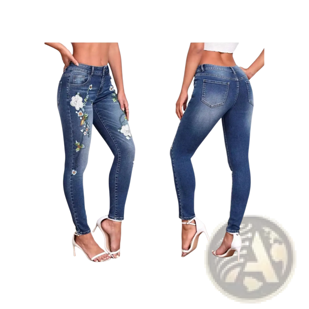 Blue denim floral embroidered high waisted skinny jeans with intricate white embroidery along the outer thigh
