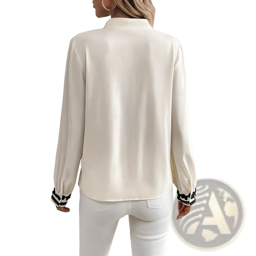 Floral embroidered long sleeve cream satin blouse with lace trim and black and white striped cuffs