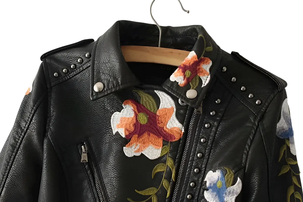 Black leather moto jacket with vibrant orange white and blue floral embroidery and silver studs on collar and zipper line