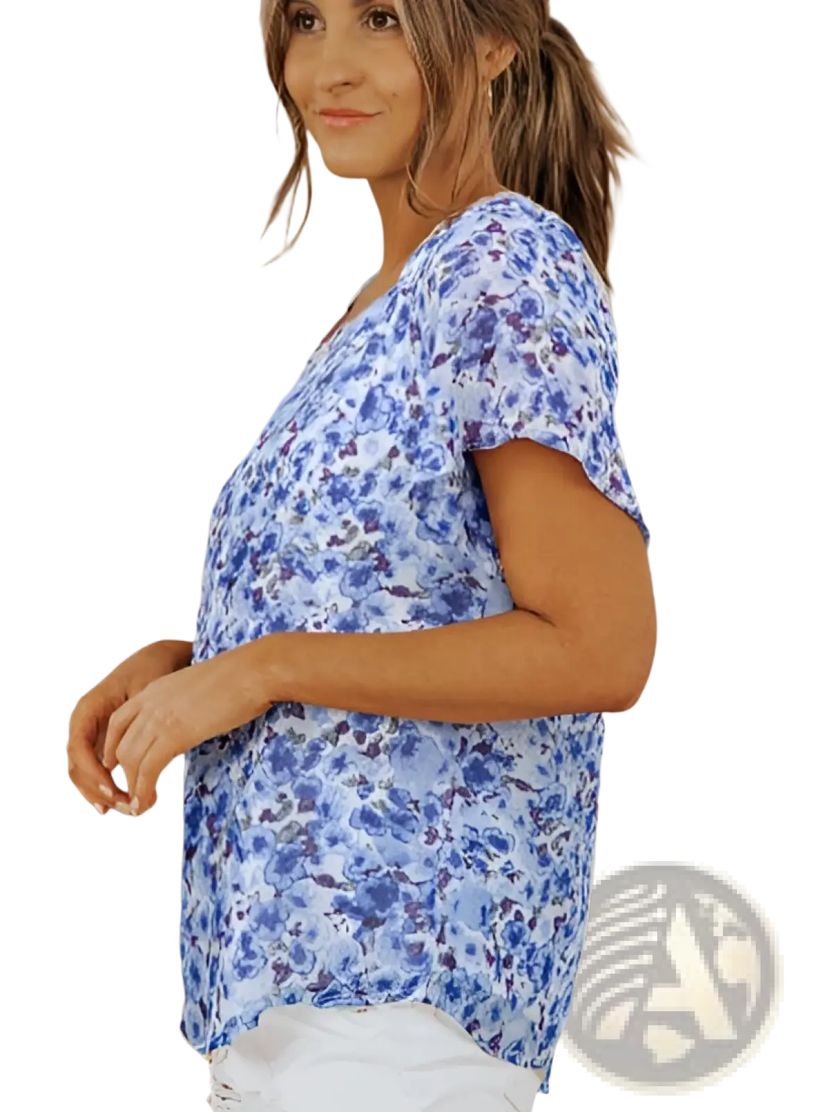 A woman wears a blue floral print short-sleeved v neck summer blouse with a slightly flared hem