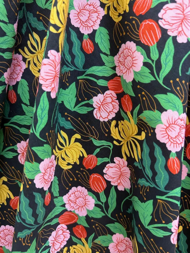 Floral Greta Green vintage cotton V neck dress featuring vibrant pink yellow and red blossoms on dark fabric