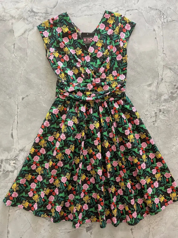 Floral Greta Green vintage cotton v neck dress with vibrant pink yellow and green blossoms on a dark background