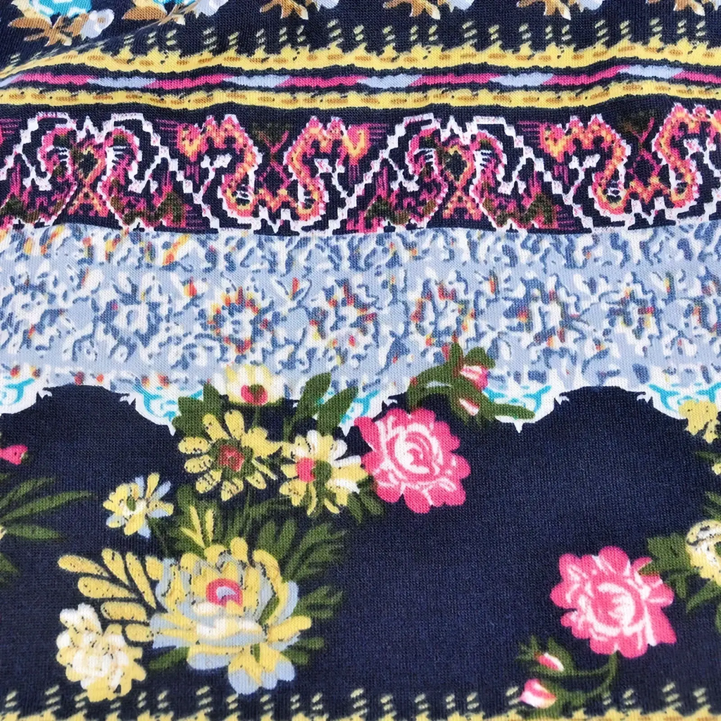 Navy blue floral knit beanie hat with pink and yellow roses and geometric borders for unisex autumn wear