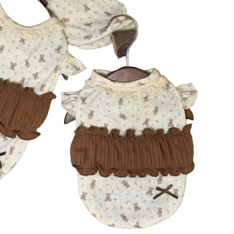 Cream-colored floral lace dog dress with brown ruffled trim and small bear print puppy shirt front view
