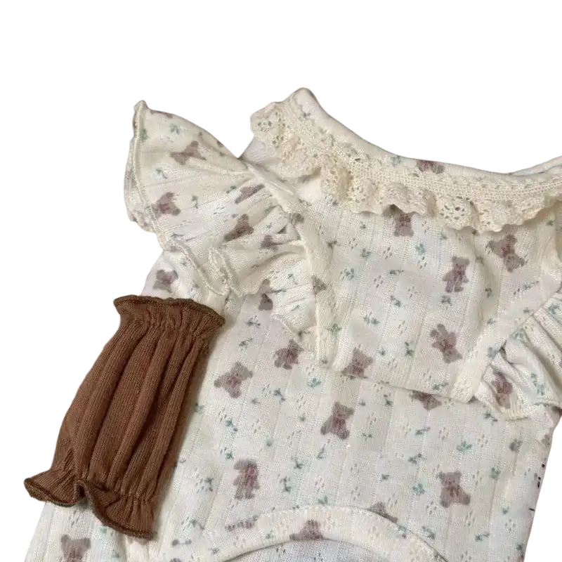 Delicate off-white baby onesie with brown teddy bear print green leaves ruffled sleeves and lace trim floral lace dog dress puppy shirt