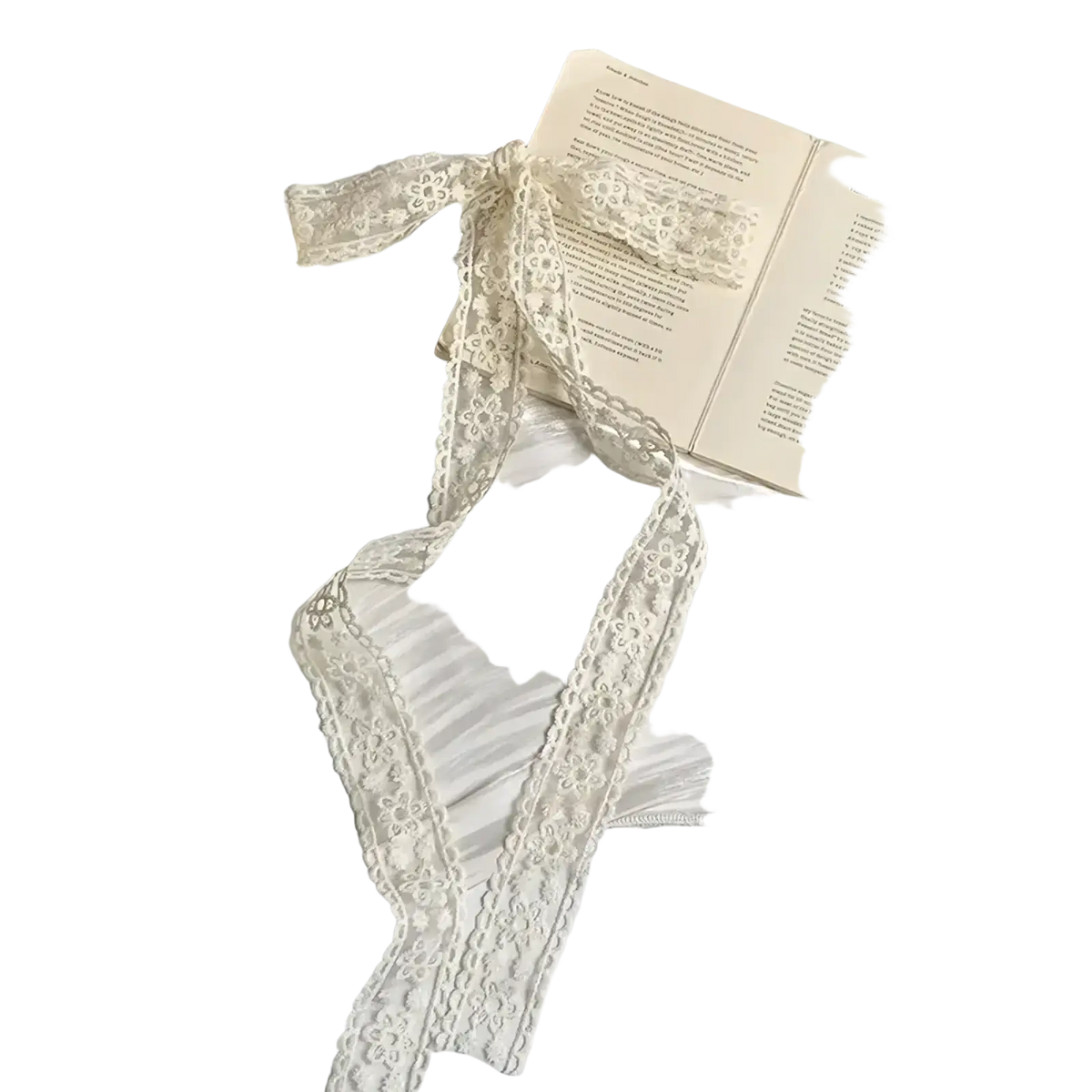 Delicate cream floral lace scarf hair bow ribbon wrap with scalloped edges tied around an open book