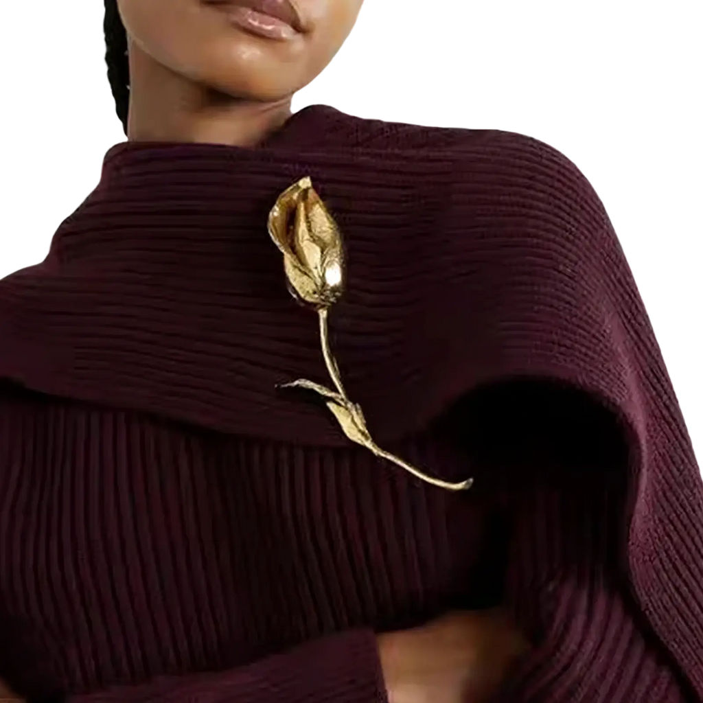 Floral metal brooch pin with gold-toned delicate rose and intricate petals on a maroon ribbed sweater neckline