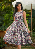Vintage floral cotton midi dress with pockets featuring a sleeveless floral print in soft purples pinks and whites