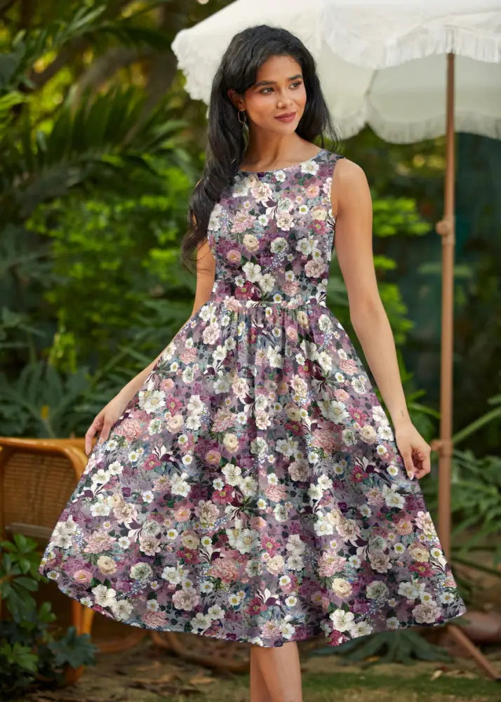 Vintage floral cotton midi dress with pockets featuring a sleeveless floral print in soft purples pinks and whites
