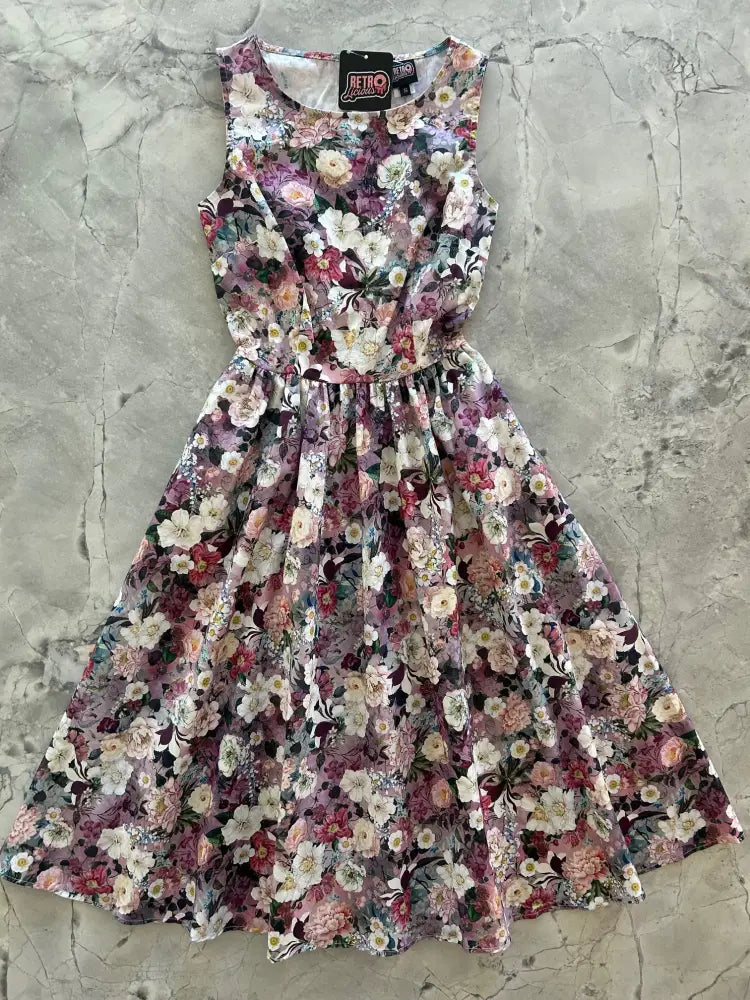 Vintage floral cotton midi dress with pockets featuring a sleeveless a-line design and soft pink purple flowers on dark background