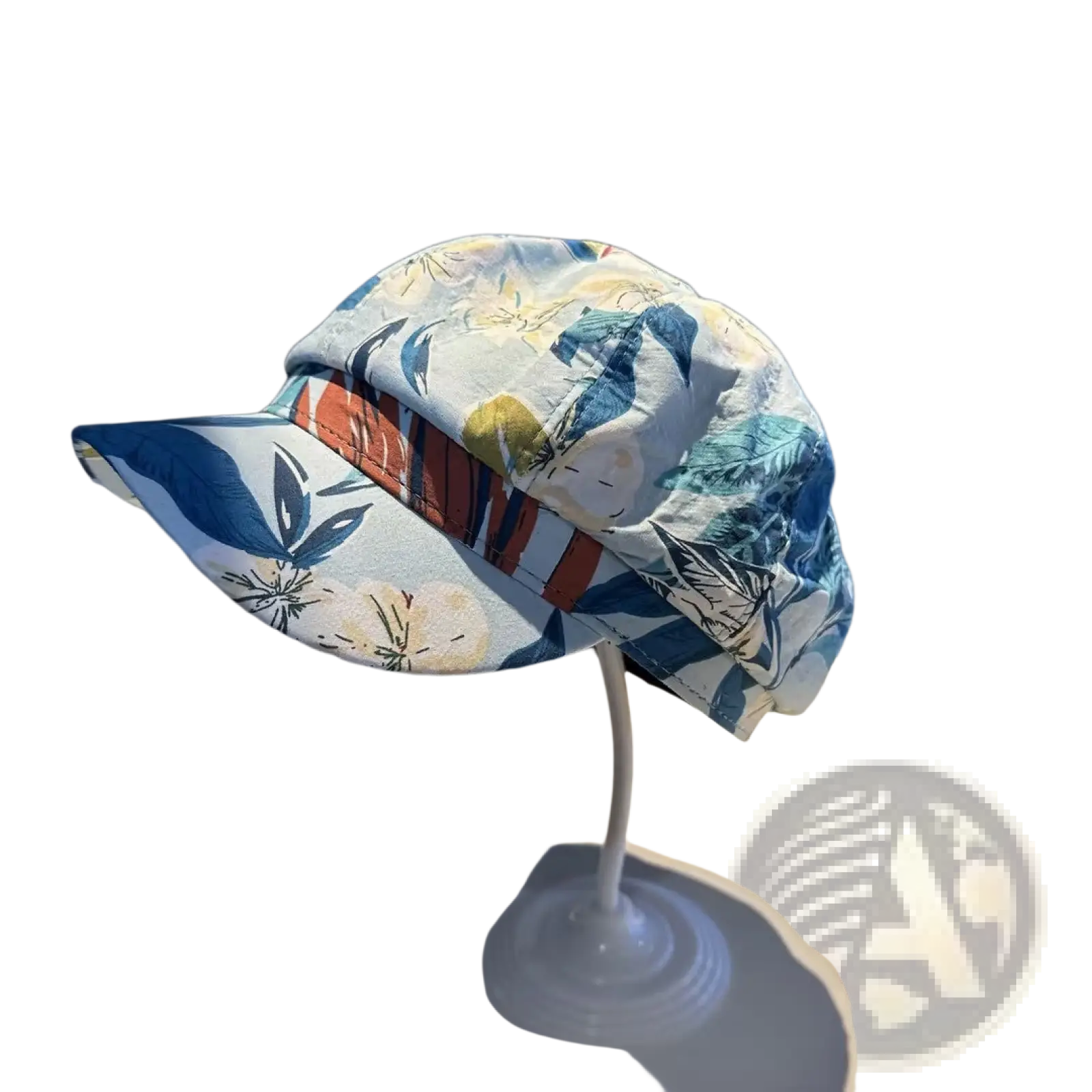 A light blue floral newsboy cap with a striped orange and brown band displayed on a white stand