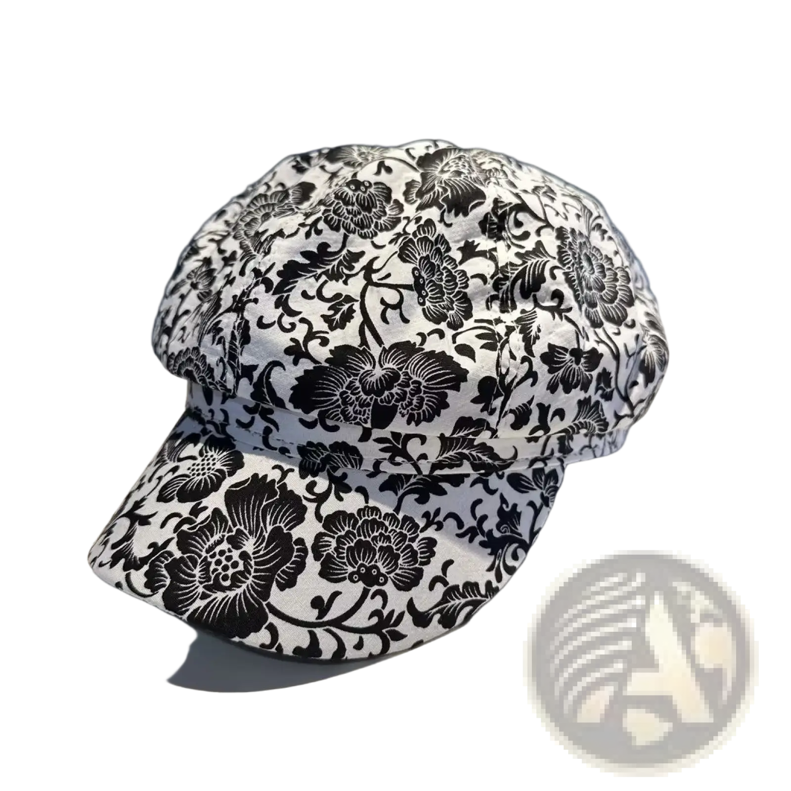 A black and white floral-patterned fabric newsboy cap for women featuring a classic design