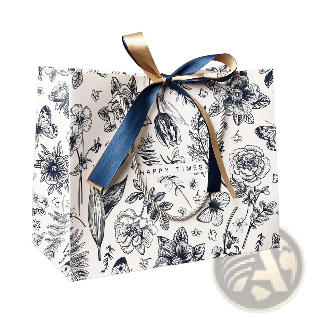 A white paper floral gift bag with black botanical illustration pattern tied with navy blue and gold ribbon bow