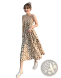 A woman wears a beige and brown leopard-print midi dress with thin spaghetti straps in a floral print halter style