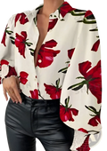 A woman wears a white blouse with bold red floral print, lantern sleeves, and lace-trimmed cuffs floral print lantern sleeve ruffled blouse
