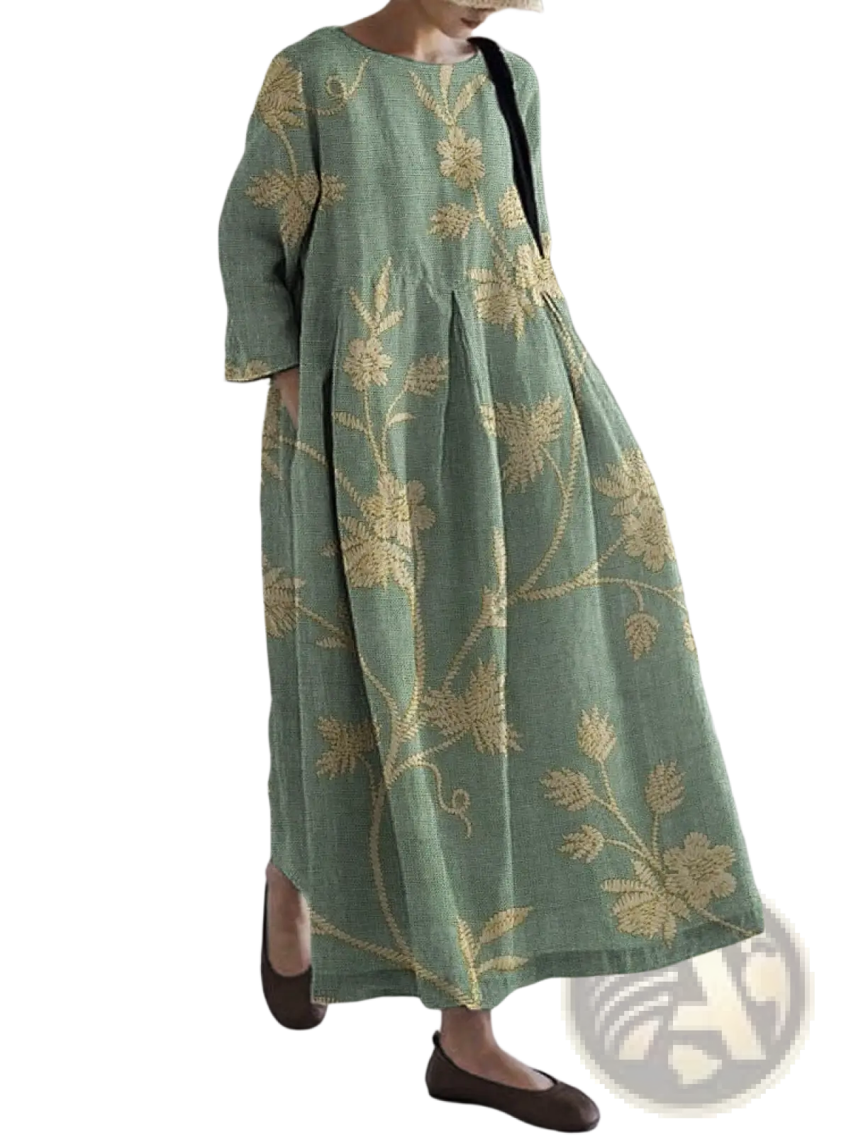A flowing sage green linen plus size A-line maxi dress with intricate gold floral embroidery and a relaxed fit