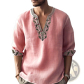 A soft pink floral print linen shirt with v neck and green gray embroidered detailing for summer pullover