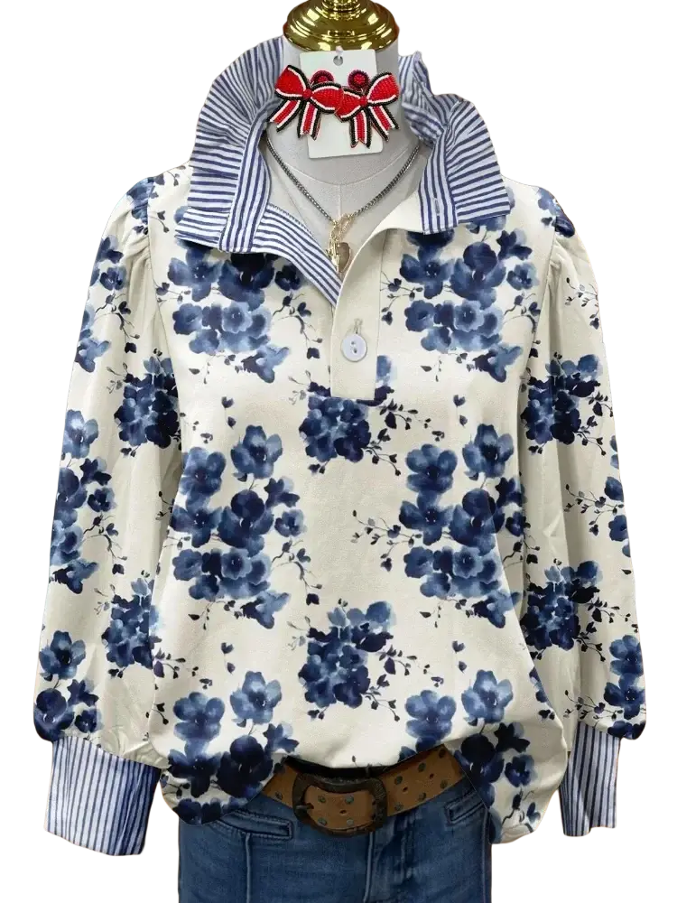Blue floral print long sleeve casual shirt with striped collar and cuffs displayed on a mannequin for customer satisfaction