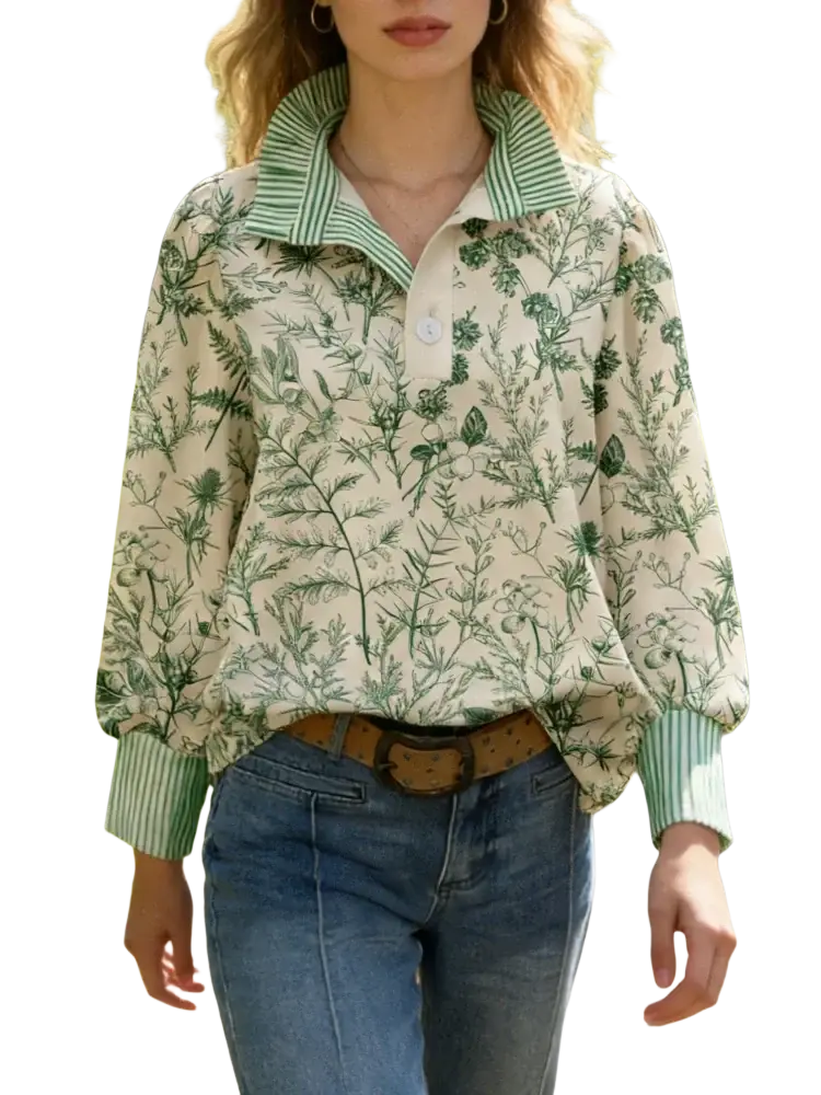 A cream-colored long sleeve casual shirt with green floral print and striped collar cuffs and placket