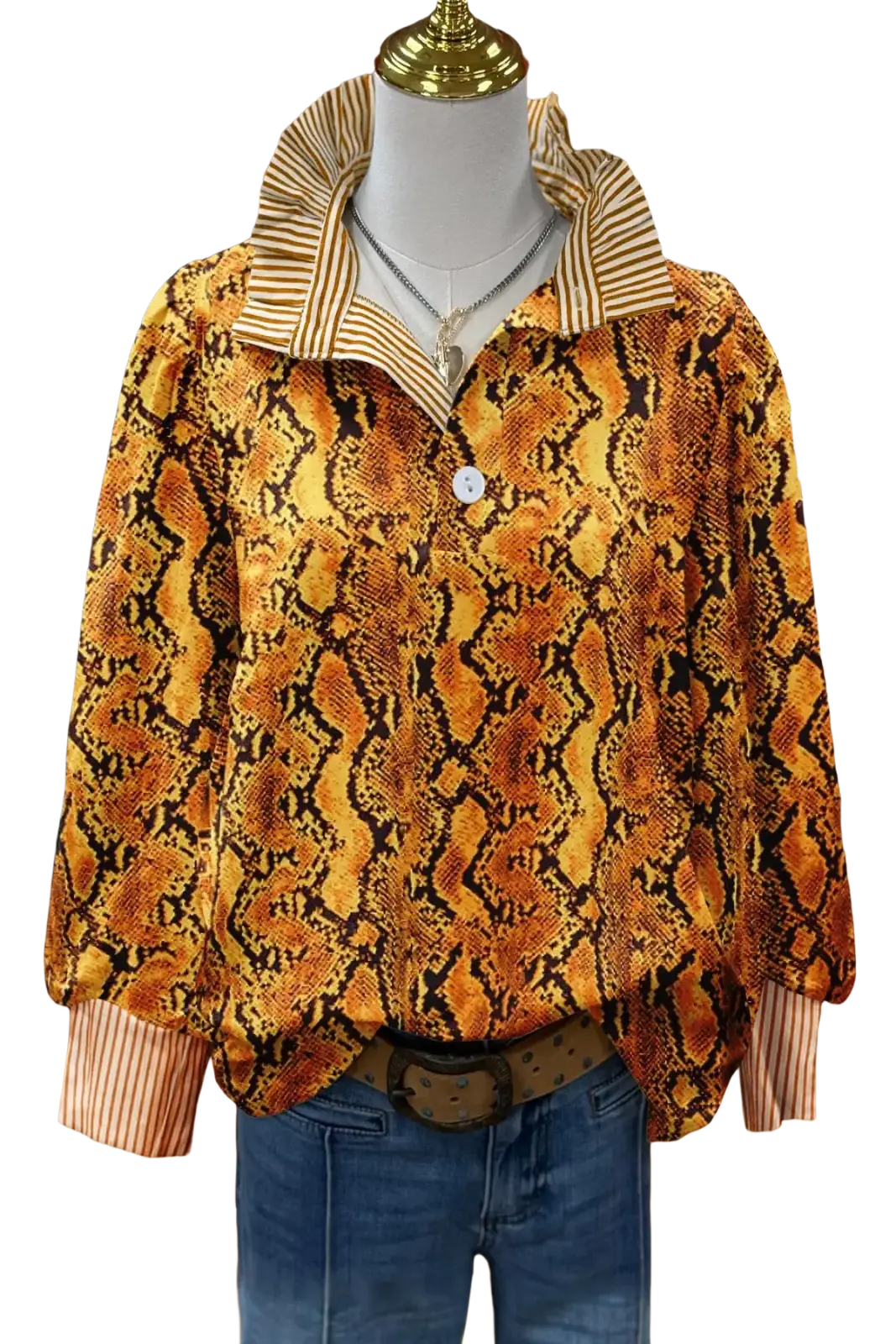 A vibrant orange and black snake-print long sleeve casual shirt with striped collar and cuffs on a mannequin