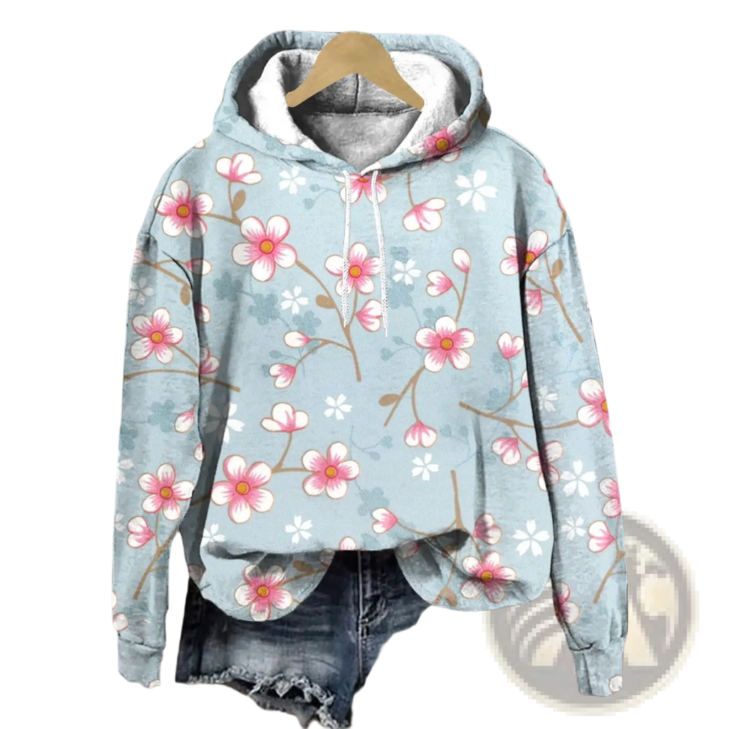 A light blue floral print loose fit hoodie with pink and white blossoms, gray-lined hood, and matching drawstrings