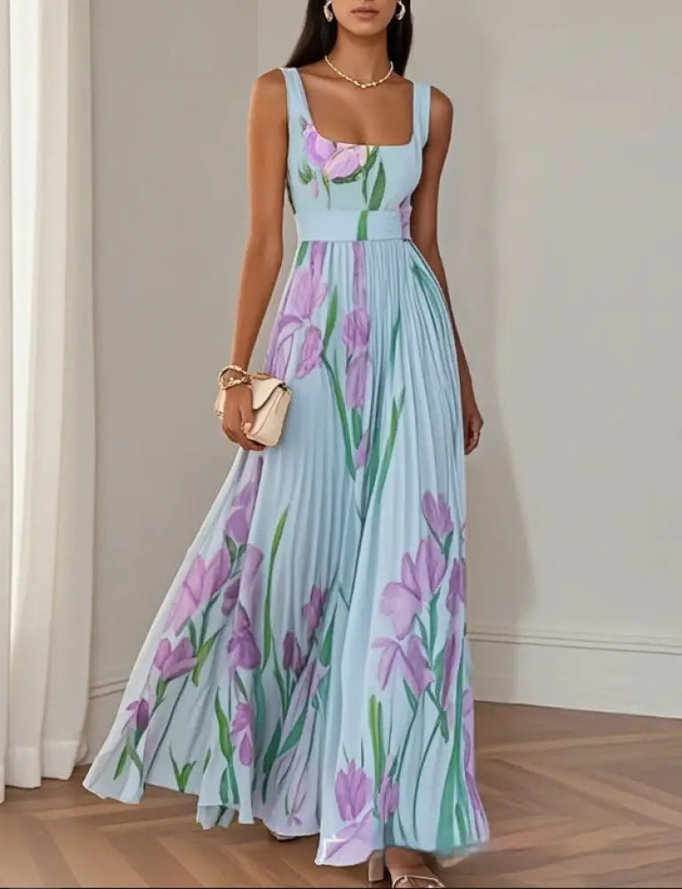A flowing light blue maxi dress with a square neckline and pleated skirt featuring a vibrant purple iris floral pattern