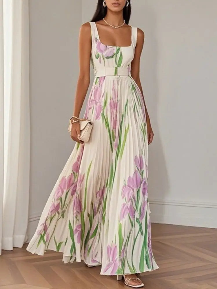 A flowing white floral iris pleated maxi dress with square neckline and thin straps featuring pink flowers