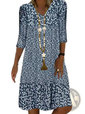 A navy blue and white floral print v neck midi dress with three quarter sleeves made of lightweight fabric