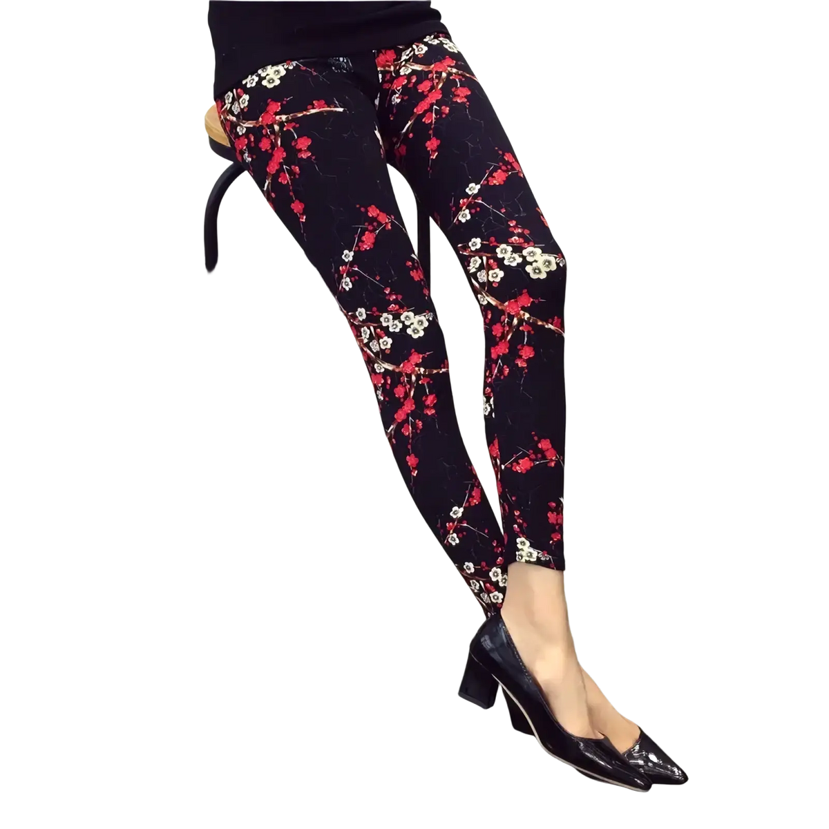 Floral print workout leggings for women featuring vibrant red and white blossoms on black fabric with slender branches
