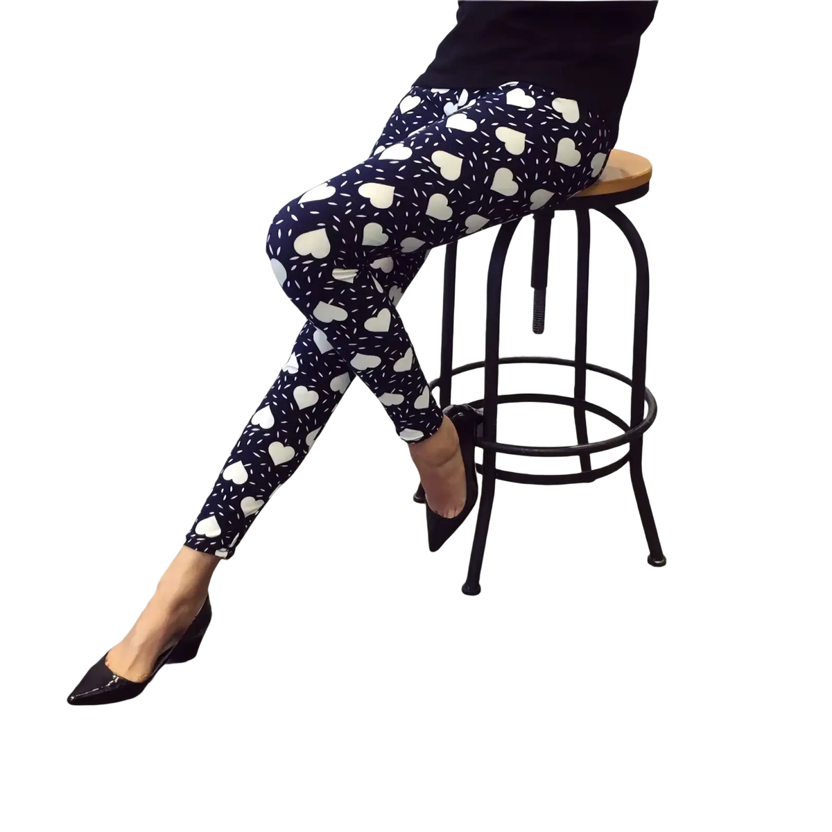 Dark blue floral print workout leggings for women featuring a white heart pattern and speckles worn with black heels