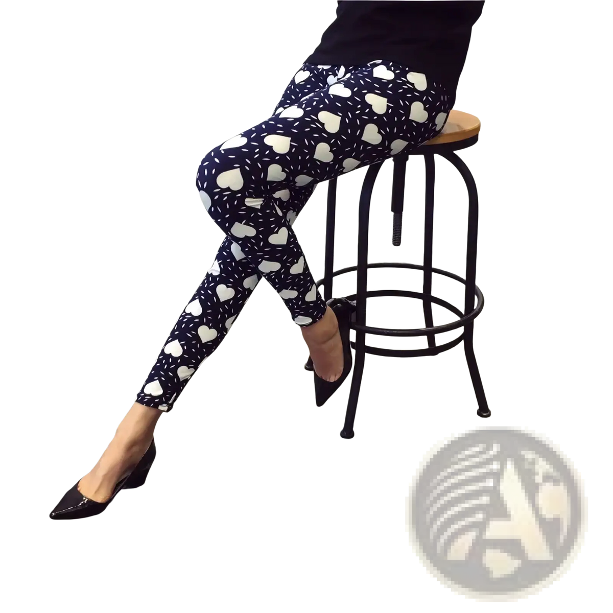 Dark blue floral print workout leggings for women featuring a white heart pattern and speckles worn with black heels