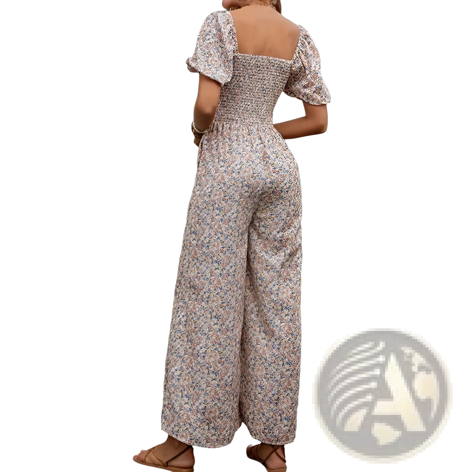 A woman wearing a beige floral print jumpsuit with puffed short sleeves and wide leg pants in a floral puff sleeve wide leg jumpsuit