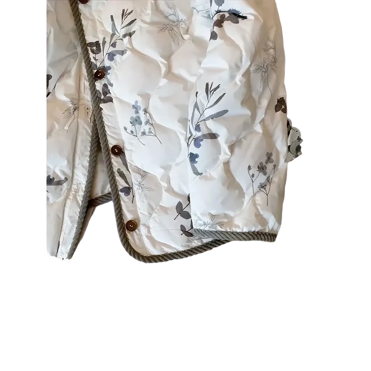 White quilted floral bomber jacket with gray botanical print, wooden buttons, and rope trim for winter wear